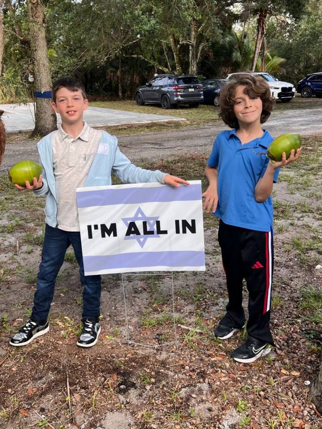 Two boys holding coconuts at Liumi